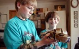2 boys with snake